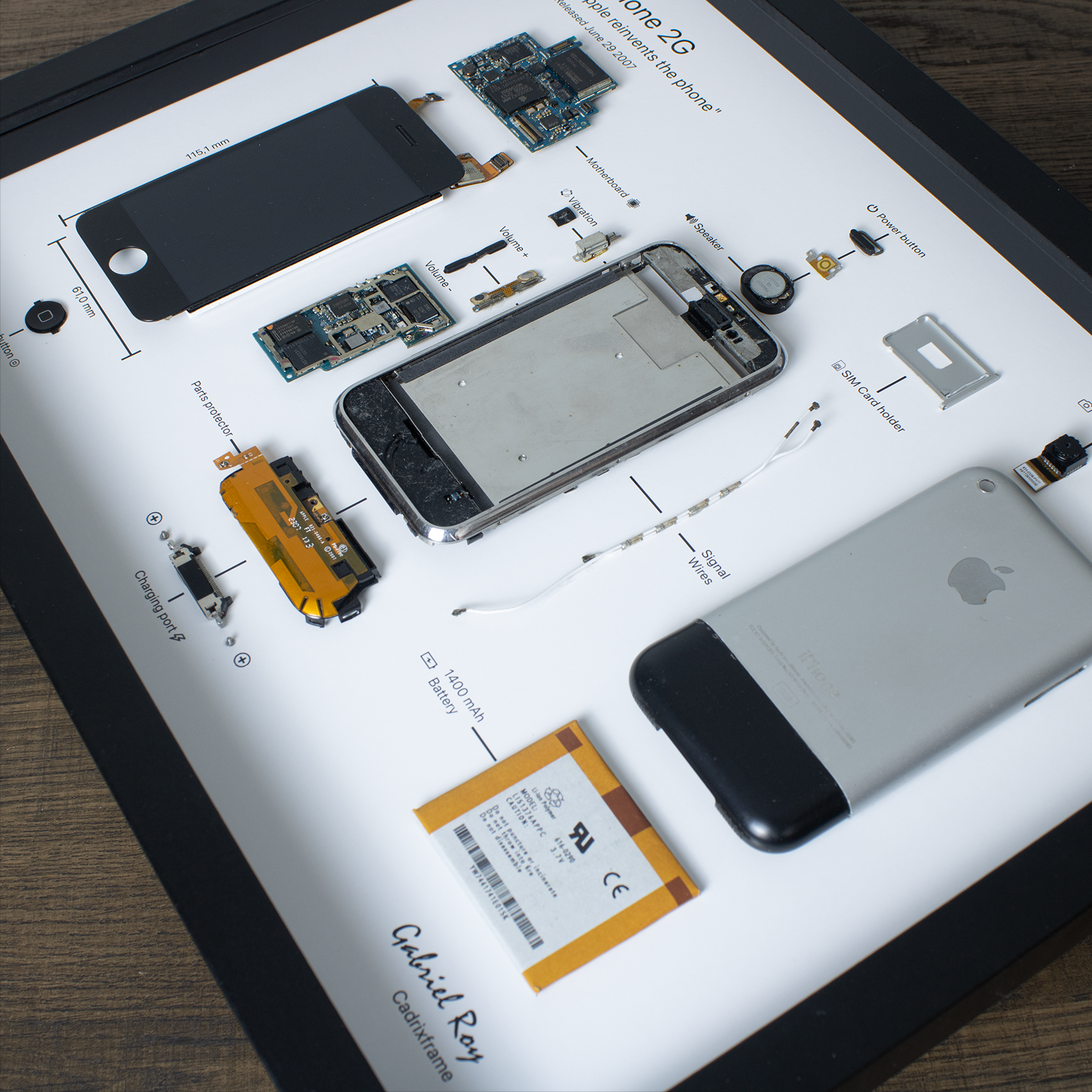 iPhone 2G disassembled in a frame